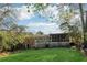 Spacious backyard featuring a well-maintained lawn, a deck and a screened porch for outdoor enjoyment at 2434 Skyland Ne Trl, Brookhaven, GA 30319