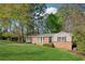 Lovely brick house with a lush front yard and mature trees offering shade and privacy in a quiet neighborhood at 2434 Skyland Ne Trl, Brookhaven, GA 30319