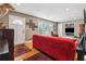Comfortable living room with hardwood floors, a red couch, and a view to the front yard at 2434 Skyland Ne Trl, Brookhaven, GA 30319