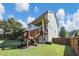 Exterior shot of a multi-story home with a deck, staircase, and a well-maintained backyard at 5386 Bluestone Cir, Mableton, GA 30126