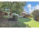 Large backyard with green grass, landscaping, and a two story deck with stairs at 5386 Bluestone Cir, Mableton, GA 30126