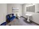 Elegant half-bathroom featuring a pedestal sink, tiled floor, and stylish blue velvet seating at 5386 Bluestone Cir, Mableton, GA 30126