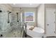 Modern bathroom featuring a walk-in shower, freestanding tub, and sleek black fixtures at 5386 Bluestone Cir, Mableton, GA 30126