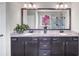 Modern bathroom with double sink vanity, granite countertops, and decorative plants at 5386 Bluestone Cir, Mableton, GA 30126