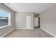 Spacious, carpeted bedroom with neutral walls, featuring a large window and two closets at 5386 Bluestone Cir, Mableton, GA 30126
