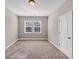 Empty bedroom with neutral walls, carpet floors, and bright, natural light from the windows at 5386 Bluestone Cir, Mableton, GA 30126