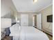 Comfortable bedroom with a white bed, neutral walls, and built in closet, illuminated by a stylish table lamp at 5386 Bluestone Cir, Mableton, GA 30126