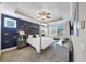 Stylish bedroom featuring a modern four poster bed, contemporary lighting, and an elegant dark blue accent wall at 5386 Bluestone Cir, Mableton, GA 30126