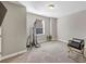 Minimalist bedroom with neutral walls, spotlighting equipment, and accent chair at 5386 Bluestone Cir, Mableton, GA 30126