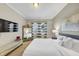 Comfortable bedroom with large mirror, large TV and bright white bedding at 5386 Bluestone Cir, Mableton, GA 30126