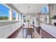 Bright dining room with hardwood floors, wainscoting, chandelier, and large windows offering a view at 5386 Bluestone Cir, Mableton, GA 30126