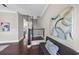 Inviting entryway showcasing hardwood floors, staircase, and decorative art above a seating bench at 5386 Bluestone Cir, Mableton, GA 30126