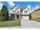 Charming two-story home with a manicured lawn, two-car garage, and inviting front porch at 5386 Bluestone Cir, Mableton, GA 30126