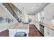 Well-lit kitchen boasting white cabinets, granite counters, stainless appliances, and pendant lights above a large island at 5386 Bluestone Cir, Mableton, GA 30126