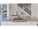 Modern kitchen island featuring granite countertop, gas cooktop, and stylish pendant lighting at 5386 Bluestone Cir, Mableton, GA 30126