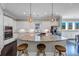 Spacious white kitchen with stainless steel appliances, granite countertops, and pendant lighting over the island at 5386 Bluestone Cir, Mableton, GA 30126
