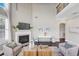 Elegant living room with a fireplace, tall windows and dark wood flooring at 5386 Bluestone Cir, Mableton, GA 30126