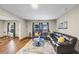 Open concept living room with a leather sofa, hardwood floors, and lots of natural light at 5386 Bluestone Cir, Mableton, GA 30126