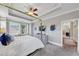 Spacious main bedroom featuring a tray ceiling, large windows, and a glimpse of the ensuite at 5386 Bluestone Cir, Mableton, GA 30126