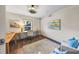 Bright home office space with natural light, hardwood floors, and a ceiling fan at 5386 Bluestone Cir, Mableton, GA 30126