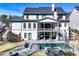 Aerial view of the home's backyard with a pool, hot tub, and two-story porch and manicured landscaping at 109 Owens Mill Pl, Canton, GA 30115