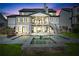 Back of the house features a two-story porch and backyard with a spa and a pool at dusk at 109 Owens Mill Pl, Canton, GA 30115