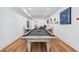 Finished basement with hardwood floors, a pool table, dining area, and ample seating at 109 Owens Mill Pl, Canton, GA 30115