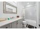 Well-lit bathroom with tiled shower/tub combination, gray vanity, and patterned floor tiles at 109 Owens Mill Pl, Canton, GA 30115