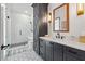 Modern bathroom features a glass-enclosed shower, sleek vanity, and stylish tile flooring at 109 Owens Mill Pl, Canton, GA 30115