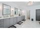 Bathroom with dual sinks, gray cabinets, and marble floors with decorative lighting at 109 Owens Mill Pl, Canton, GA 30115