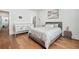 Stylish bedroom featuring hardwood floors, a queen-sized bed, and a bright window at 109 Owens Mill Pl, Canton, GA 30115