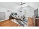 Cozy bedroom with hardwood flooring, modern ceiling fan, neutral-colored walls, and bright natural light at 109 Owens Mill Pl, Canton, GA 30115