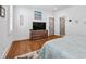 Bright bedroom with hardwood floors and a comfortable queen-sized bed, complete with a dresser and TV at 109 Owens Mill Pl, Canton, GA 30115