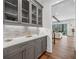 Elegant butler's pantry with modern cabinetry, tile backsplash, and hardwood floors at 109 Owens Mill Pl, Canton, GA 30115
