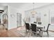 Formal dining room with hardwood floors, elegant chandelier, and views to the outside at 109 Owens Mill Pl, Canton, GA 30115