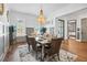 Bright dining room with hardwood floors, elegant chandelier, and modern wainscoting at 109 Owens Mill Pl, Canton, GA 30115