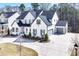 Charming two-story home featuring a modern farmhouse exterior with a spacious driveway and manicured landscaping at 109 Owens Mill Pl, Canton, GA 30115