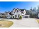 Attractive home showcasing a three car garage, green lawn, and a well-kept garden at 109 Owens Mill Pl, Canton, GA 30115