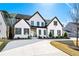 Home with a spacious driveway, beautiful landscaping, and classic architectural design at 109 Owens Mill Pl, Canton, GA 30115