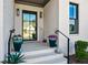 Inviting front porch with stylish planters and a glass-paneled front door entrance at 109 Owens Mill Pl, Canton, GA 30115