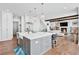 Spacious kitchen with large island overlooking the living room with a fireplace at 109 Owens Mill Pl, Canton, GA 30115