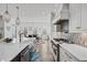 Gourmet kitchen featuring stainless steel appliances, custom cabinets, and quartz countertops at 109 Owens Mill Pl, Canton, GA 30115