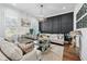 Bright living room with dark accent wall, hardwood floors, and stylish furnishings at 109 Owens Mill Pl, Canton, GA 30115