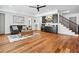 Open-concept living area featuring sleek hardwood floors and a stylish wet bar area at 109 Owens Mill Pl, Canton, GA 30115