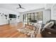 Bright living room showcasing hardwood floors, a ceiling fan, and modern glass doors to patio at 109 Owens Mill Pl, Canton, GA 30115