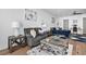 Cozy sitting area features a comfortable sofa, stylish decor, and hardwood flooring at 109 Owens Mill Pl, Canton, GA 30115