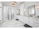 Elegant main bathroom with dual vanities, marble floors, and a stunning chandelier at 109 Owens Mill Pl, Canton, GA 30115