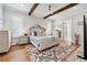 Spacious main bedroom with hardwood floors, decorative rug, beamed ceiling, and lots of natural light at 109 Owens Mill Pl, Canton, GA 30115