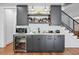 Modern wet bar features gray cabinets, a wine fridge, and a marble countertop at 109 Owens Mill Pl, Canton, GA 30115