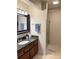 Bathroom features granite counters, updated cabinets, a framed mirror and a glass door shower enclosure at 507 Madison Se Ct, Smyrna, GA 30080
